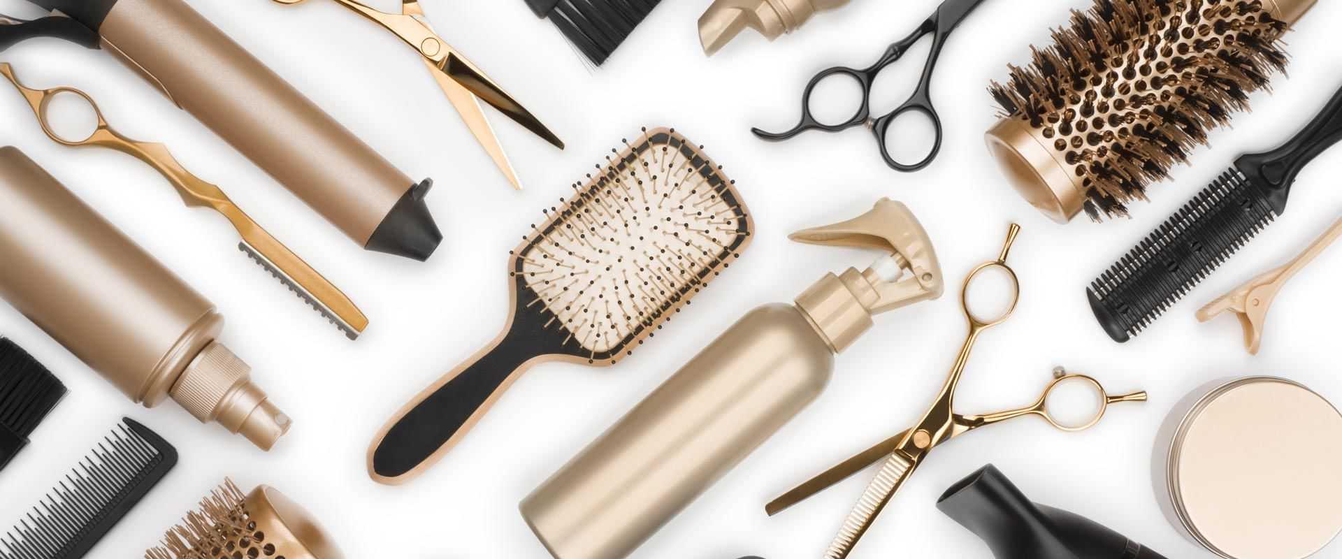 Hair styling tools and products, including scissors, brushes, spray bottles, and combs.