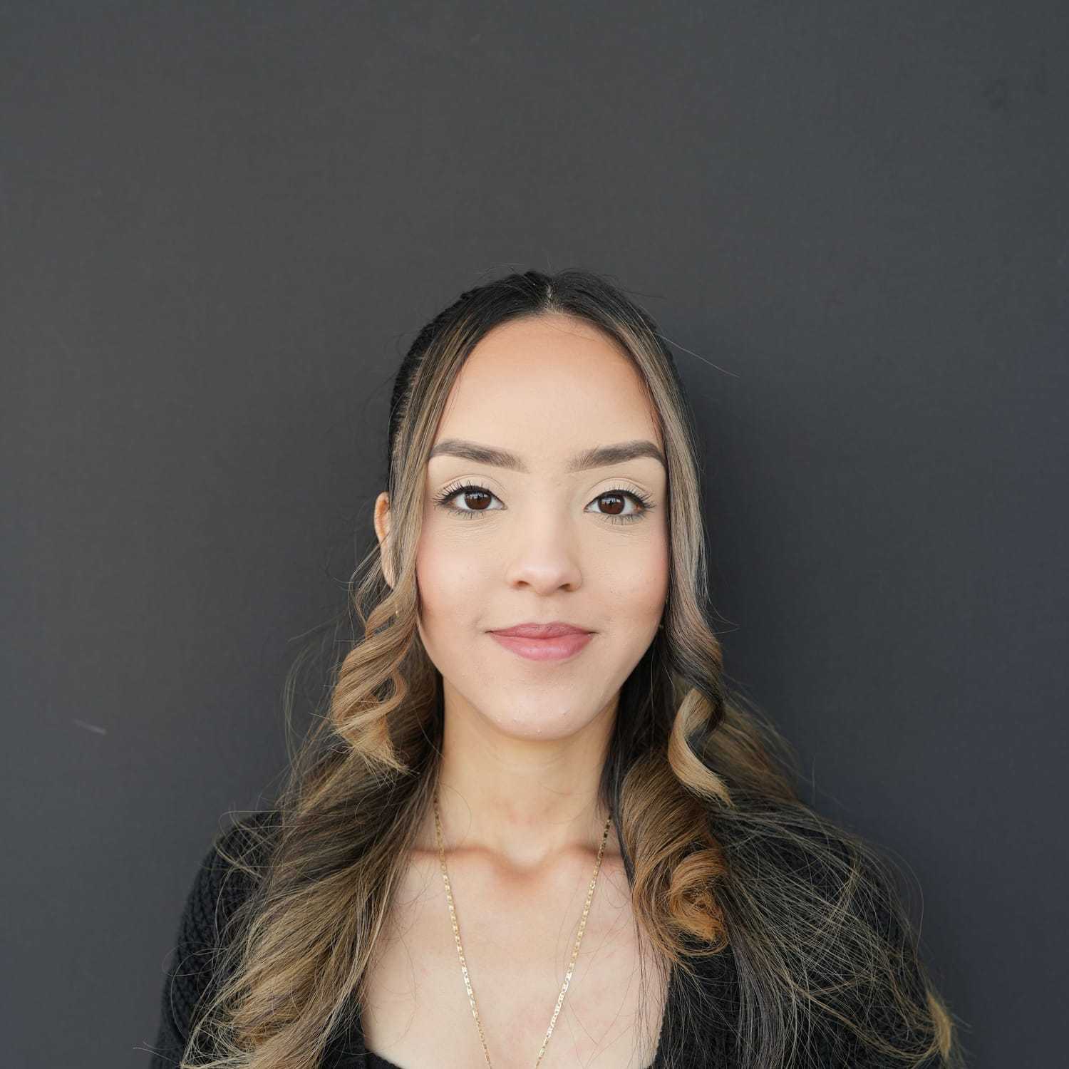 Portrait of Jannely, a professional stylist at Frank Gironda  Salons, showcasing their expertise and style.