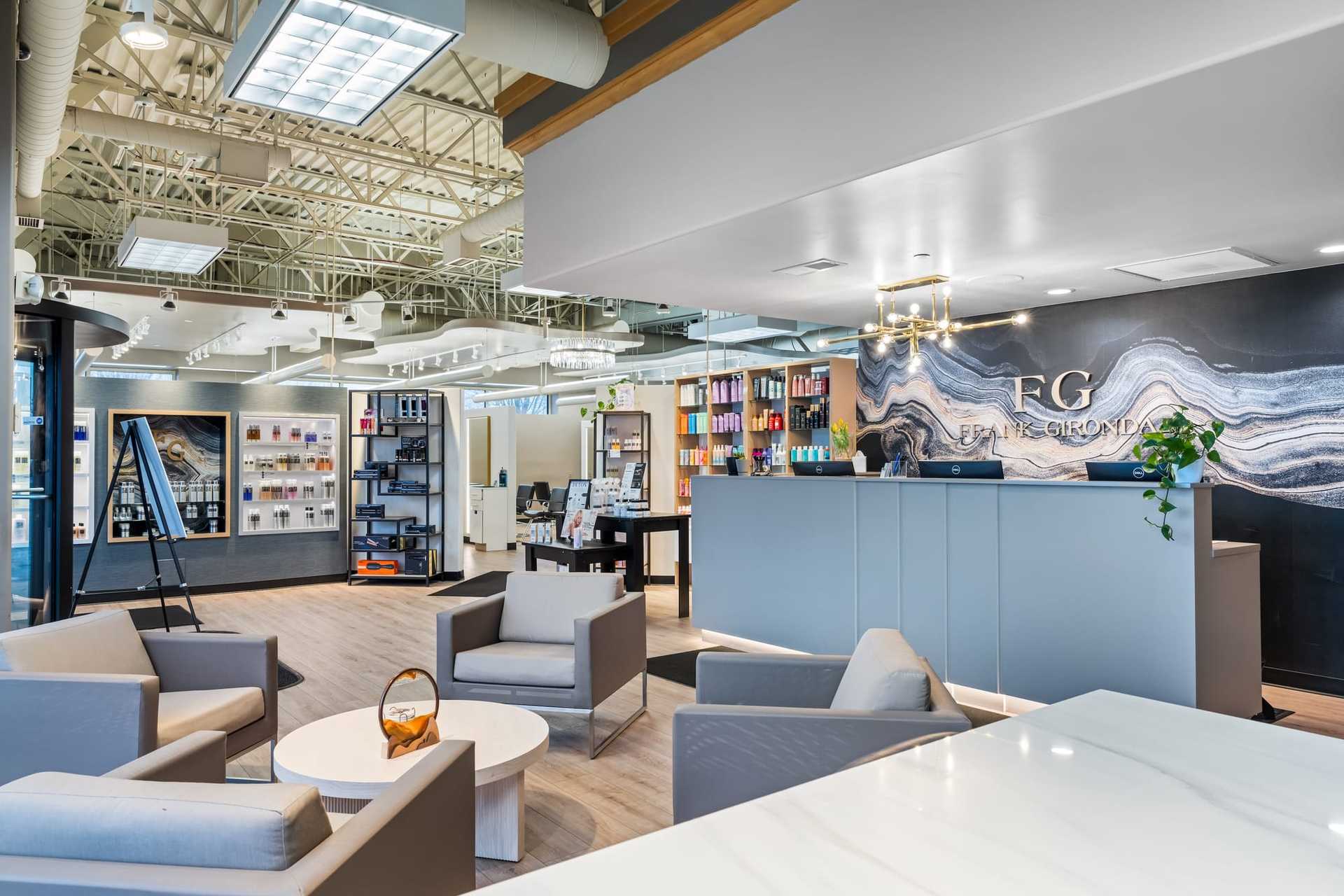 Spacious modern office lobby with seating area, stylish decor, and a reception desk.